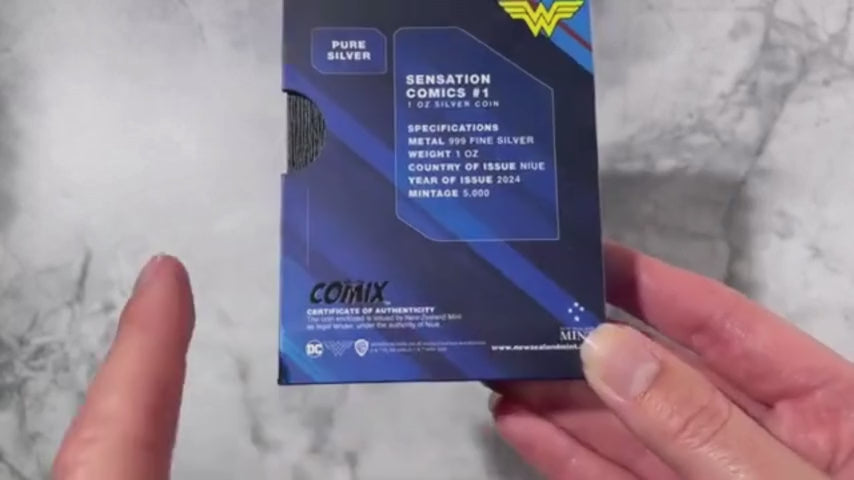 Load video: video of 2024 1 oz silver coin featuring the iconic cover art of Sensation Comics #1 with Wonder Woman, $2 Niue denomination, presented in a custom-designed comic book-themed box with a numbered Certificate of Authenticity.